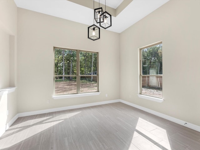 unfurnished dining area featuring an inviting chandelier