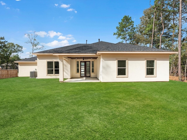 rear view of house featuring a yard, a patio, and central AC