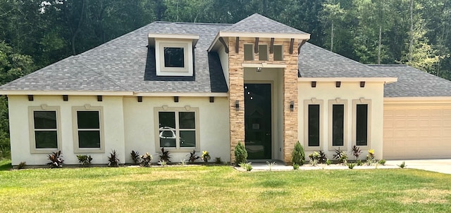 view of front facade with a front yard and a garage