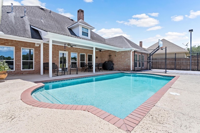 view of pool with a patio, ceiling fan, and a grill