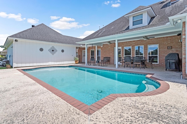 view of swimming pool featuring area for grilling, ceiling fan, and a patio area