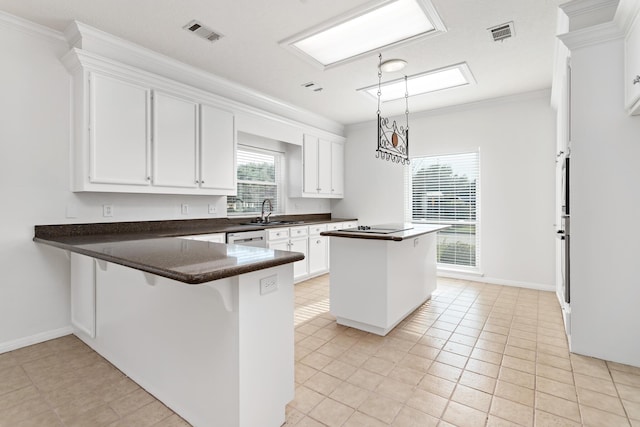 kitchen featuring a kitchen bar, kitchen peninsula, white cabinets, and light tile patterned flooring