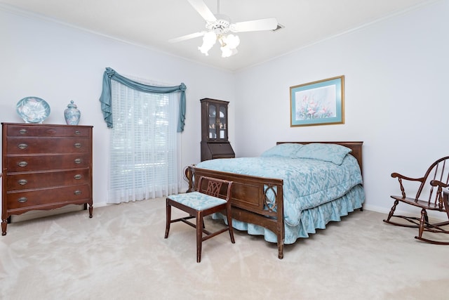 bedroom with ceiling fan, crown molding, and light colored carpet