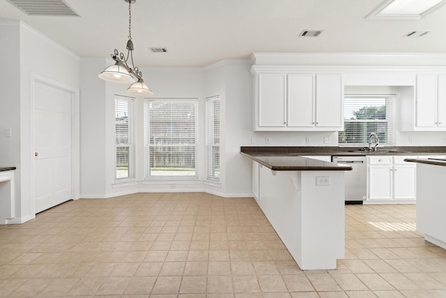 kitchen featuring crown molding, hanging light fixtures, stainless steel dishwasher, a kitchen bar, and white cabinetry