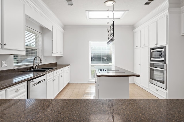 kitchen featuring pendant lighting, white cabinets, and appliances with stainless steel finishes