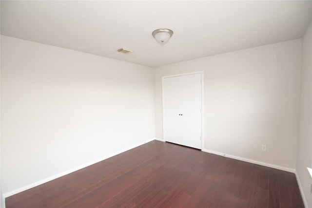 empty room with dark hardwood / wood-style floors