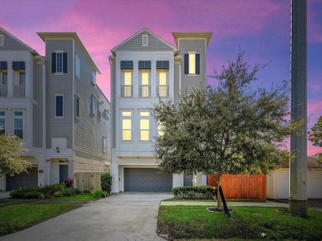 view of front of property featuring a garage and a lawn