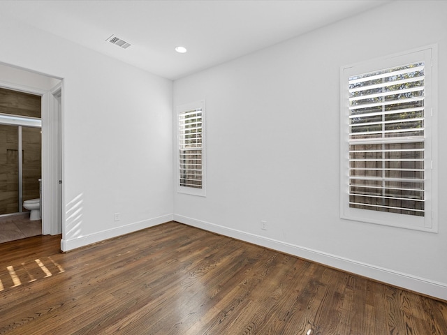 spare room with dark wood-type flooring