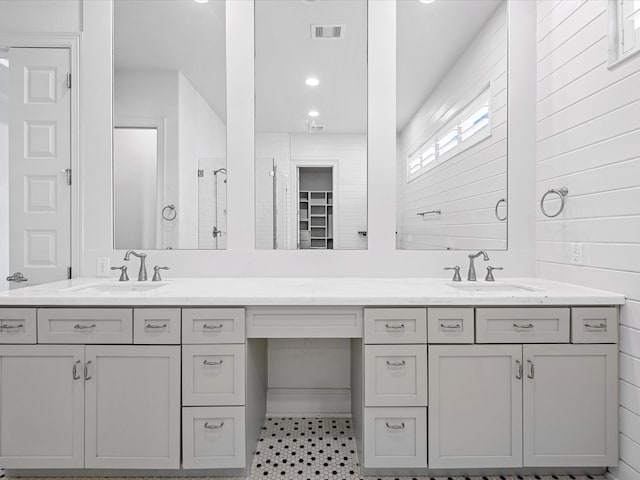 bathroom featuring vanity and wooden walls