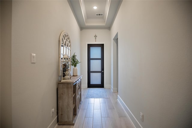 doorway with a raised ceiling and a high ceiling