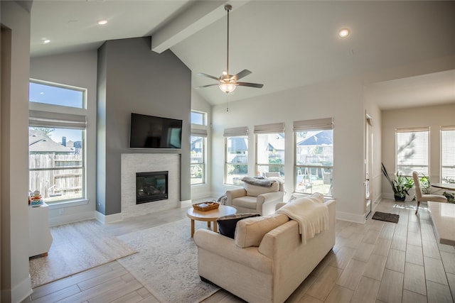 living room with beam ceiling, ceiling fan, and high vaulted ceiling