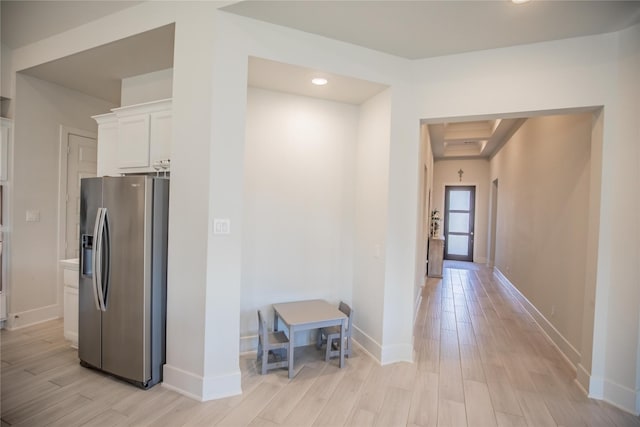 hallway with beamed ceiling, light wood-type flooring, and coffered ceiling