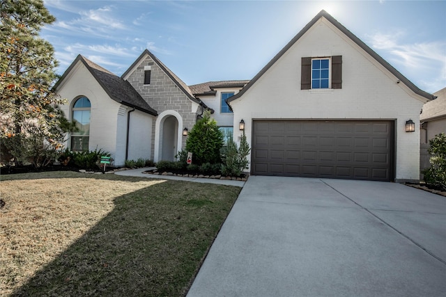 view of front of property featuring a front yard and a garage