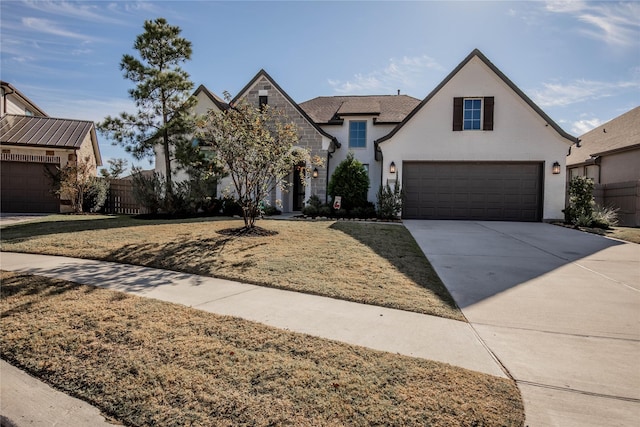 view of front of home with a front yard and a garage