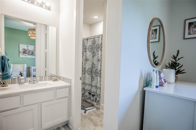 bathroom with curtained shower and vanity