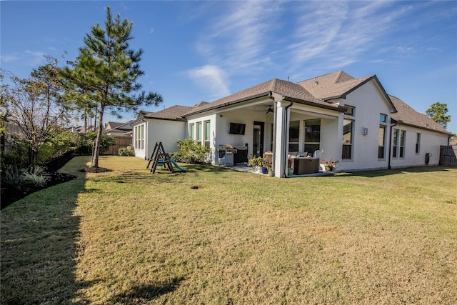 back of house with a yard, ceiling fan, and a patio area