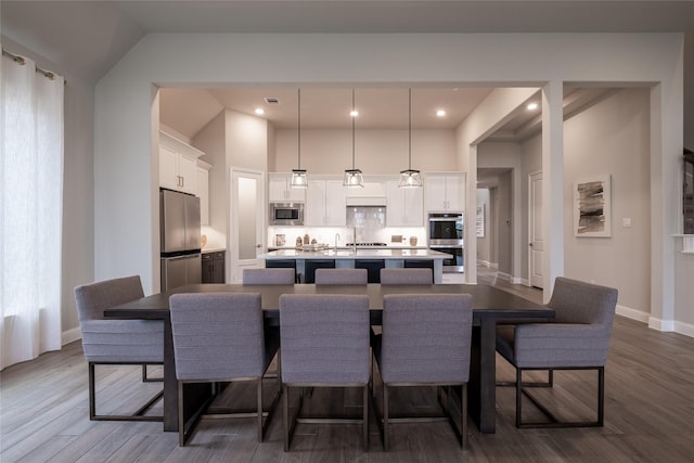 dining space with dark wood-type flooring and lofted ceiling