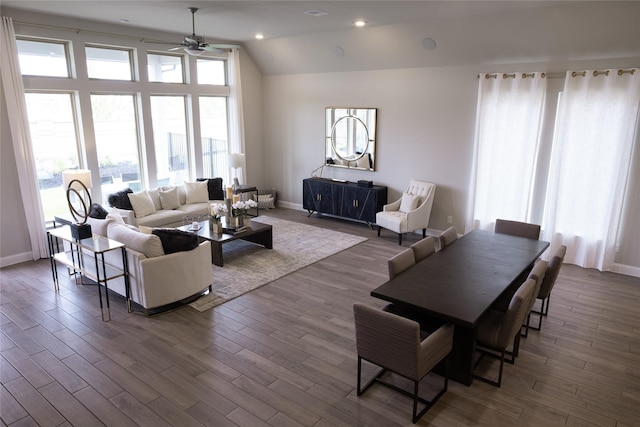 living area with lofted ceiling, ceiling fan, dark wood finished floors, and baseboards