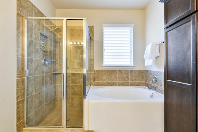 bathroom with separate shower and tub and a wealth of natural light