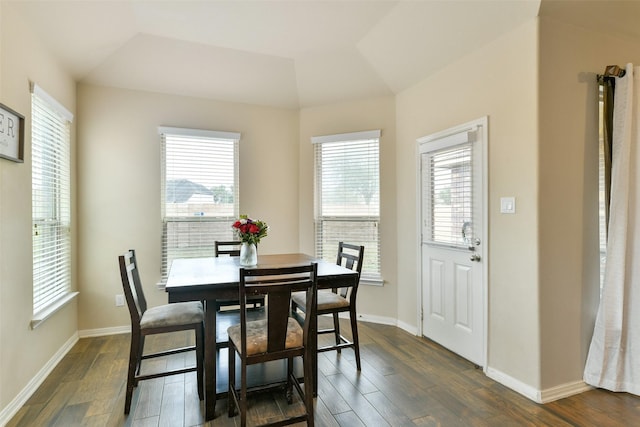 dining area featuring dark wood-type flooring and lofted ceiling