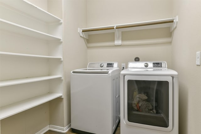 laundry area with washing machine and clothes dryer