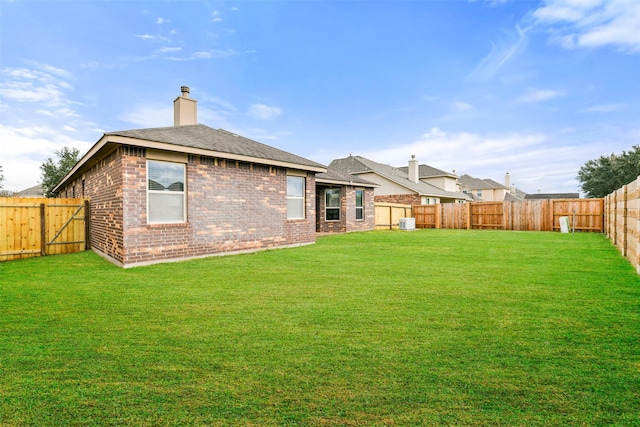 back of property featuring central air condition unit and a lawn