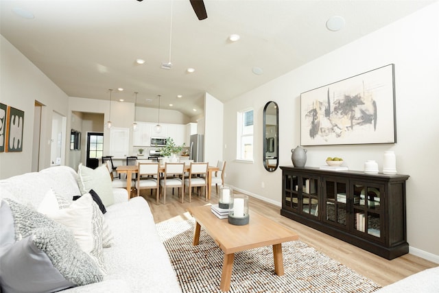 living room featuring ceiling fan and light hardwood / wood-style floors