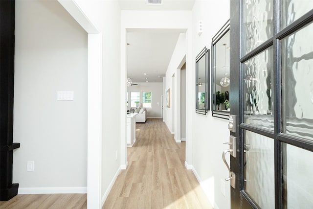 hallway with light wood-type flooring