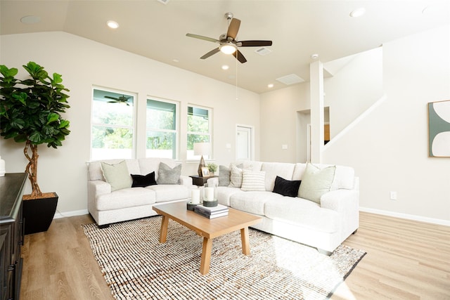 living room with light wood-type flooring, ceiling fan, and lofted ceiling