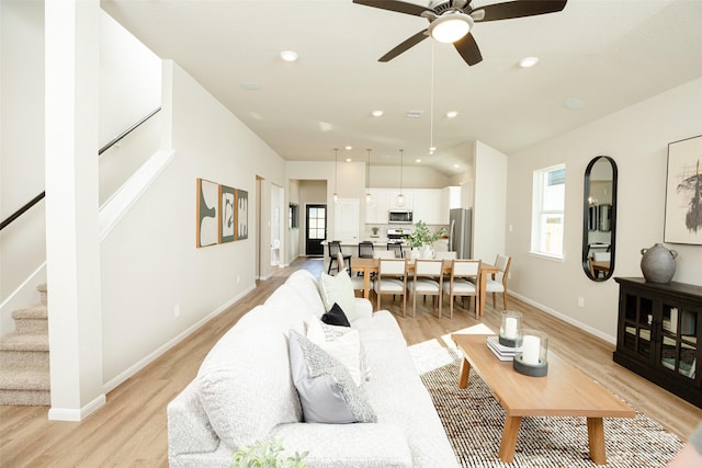 living room featuring light hardwood / wood-style flooring and ceiling fan