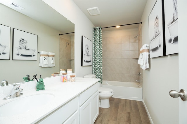 full bathroom with hardwood / wood-style floors, vanity, toilet, and shower / tub combo