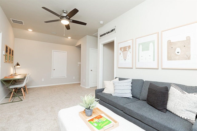 carpeted living room with ceiling fan and lofted ceiling