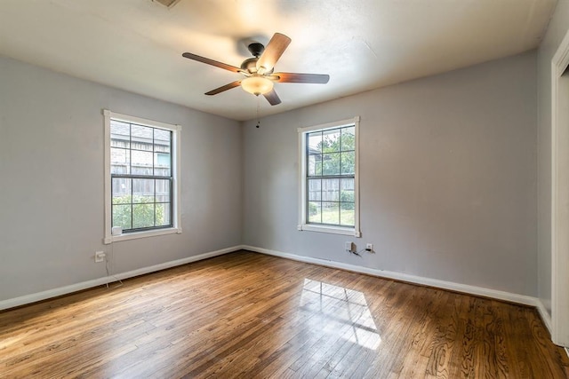 unfurnished room with ceiling fan, a healthy amount of sunlight, and wood-type flooring