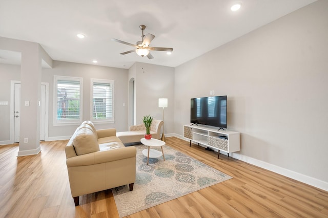 living room featuring ceiling fan and light hardwood / wood-style flooring