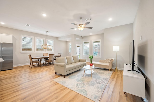 living room featuring ceiling fan and light wood-type flooring