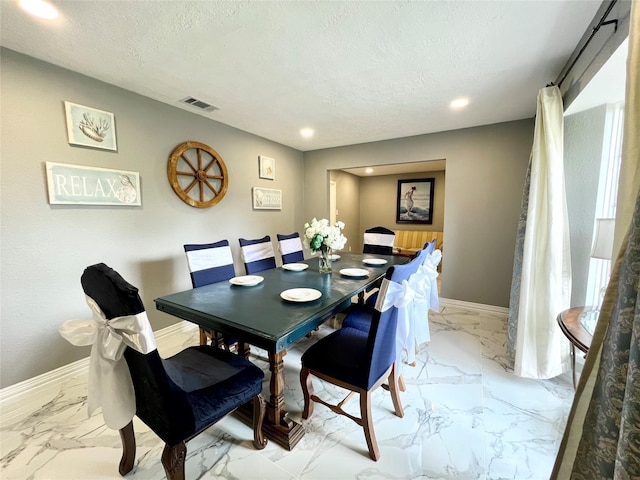 dining area with a textured ceiling