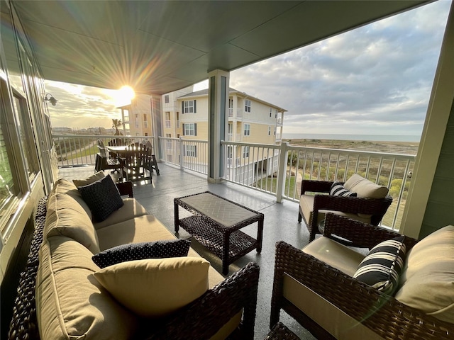 balcony at dusk with a water view and an outdoor hangout area