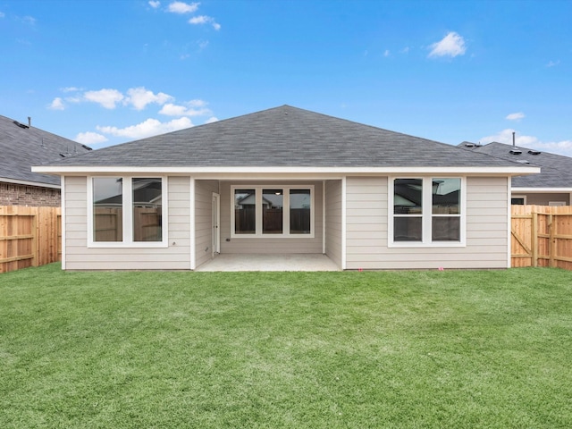 rear view of property with a patio area and a lawn