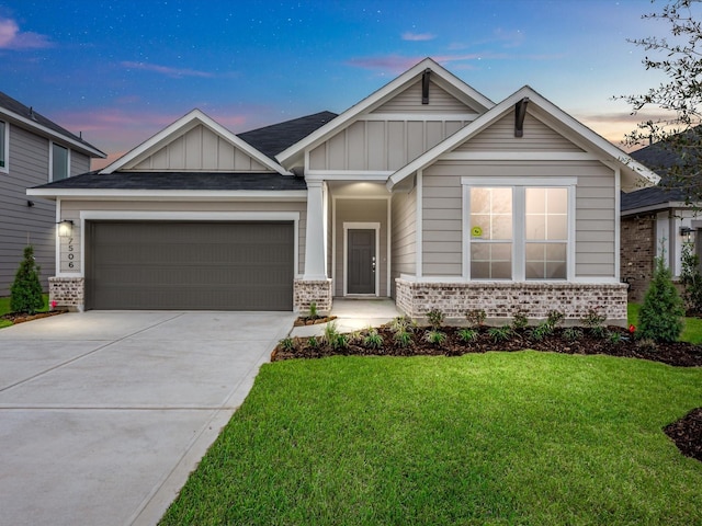 craftsman inspired home featuring a garage and a lawn