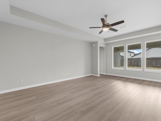 spare room with ceiling fan and light wood-type flooring