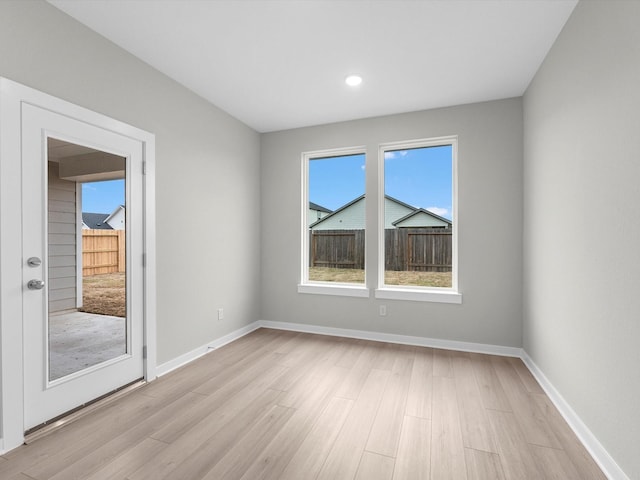 empty room with light hardwood / wood-style flooring