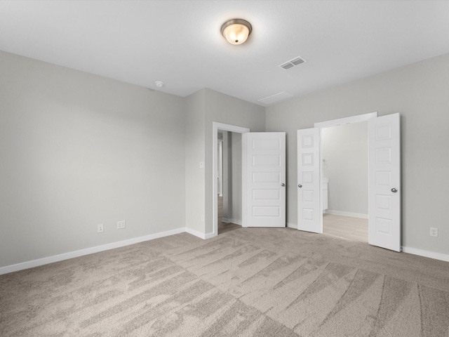 unfurnished bedroom with light colored carpet