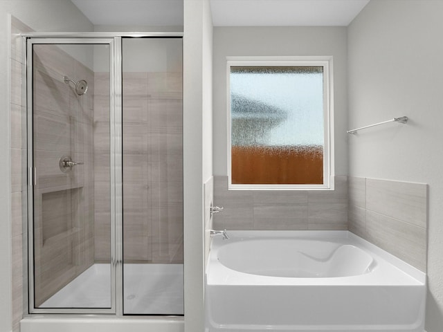 bathroom with separate shower and tub