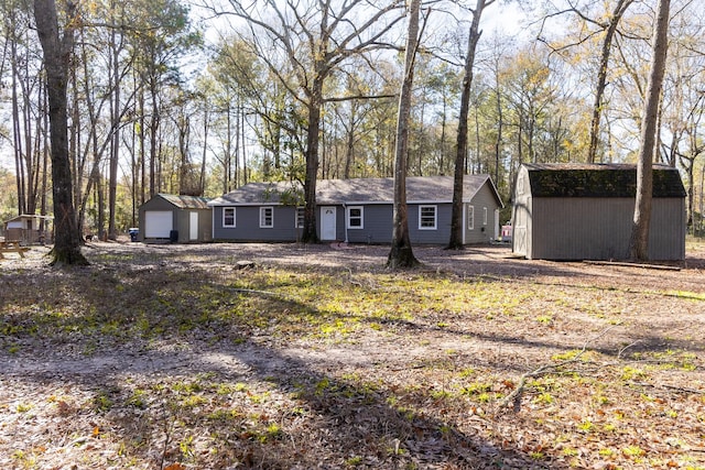 view of front of house featuring a storage shed and a garage