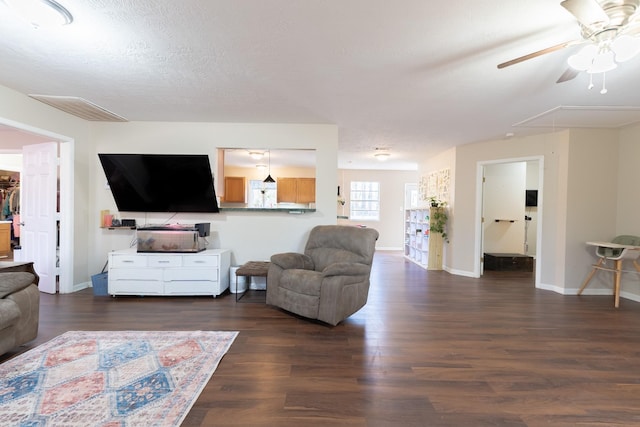 living room featuring a textured ceiling and dark hardwood / wood-style flooring