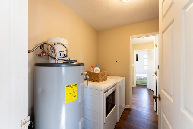 laundry area with dark hardwood / wood-style floors, a textured ceiling, water heater, and washing machine and clothes dryer