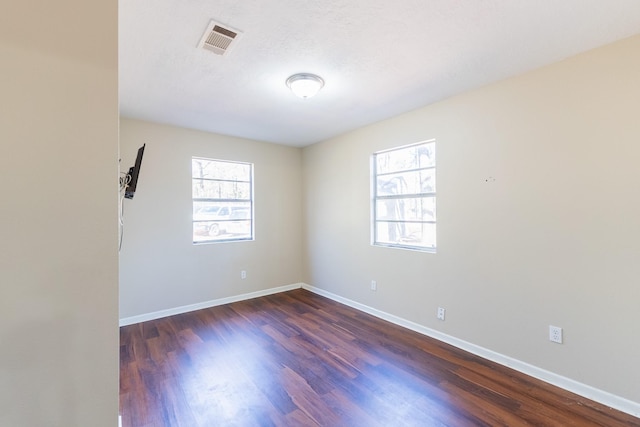 spare room featuring dark hardwood / wood-style flooring