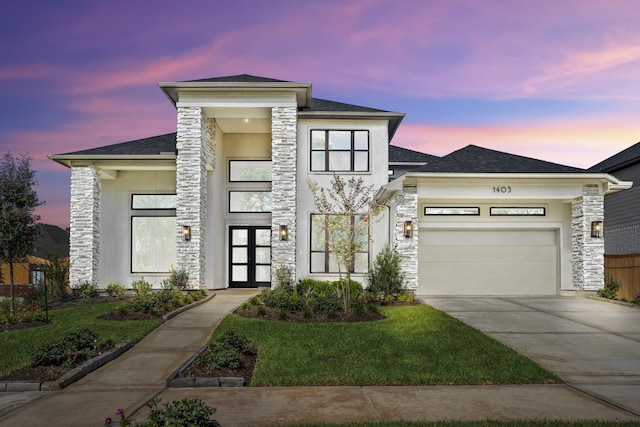 view of front of home featuring a lawn and a garage