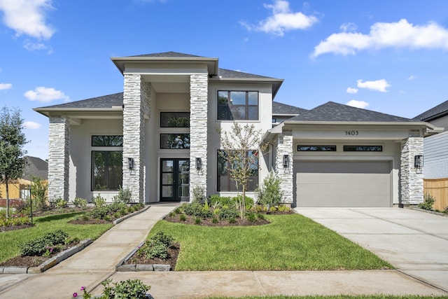 view of front of home featuring a front yard and a garage