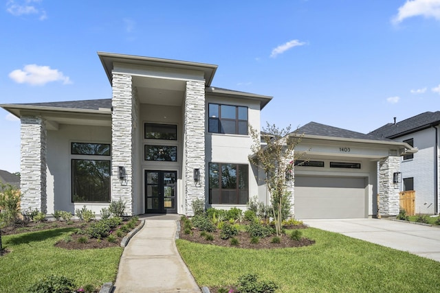 contemporary house with a front yard, french doors, and a garage